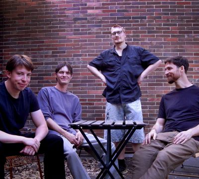 Cryptids band photo at a small table